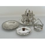 A silver plated egg cup stand with six egg cups and spoons