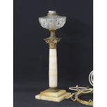 A vintage onyx and glass oil lamp