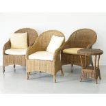 A set of three wicker rattan conservatory easy chairs