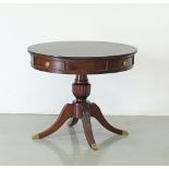 A mahogany round drum center table