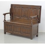 A carved oak polymorphic box settle
