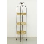 An etagere with three round wicker shelves