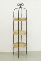 An etagere with three round wicker shelves