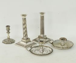 Four white metal candlesticks