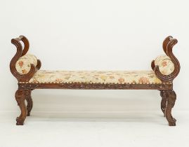 A large carved and stained wood window seat