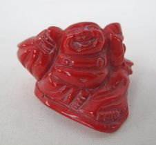 A carved red coral Buddha