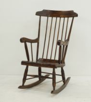 A spindle back stained beech Windsor rocking chair