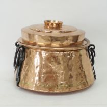 A lidded copper cauldron