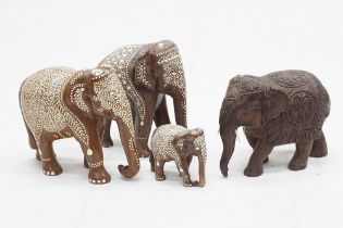 Four carved hardwood Asian elephants