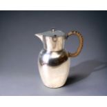 A WMF SILVER PLATED JUG. WITH FLIP-LID AND WICKER WRAPPED HANDLE. MARKED TO BASE. HEIGHT - 16CM