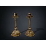 A PAIR OF AESTHETIC DESIGN BRASS CANDLESTICKS. UNUSUAL FOUNDRY MARK TO BASE. HEIGHT - 18CM