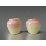A PAIR OF HAND MADE OPAL GLASS VASES. YELLOW WITH PINK STREAKS. HEIGHT - 9CM