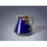 A CHRISTOHPER DRESSER FOR GEORGE JONES 'KUMASSIE' JUG. CIRCA 1875. ROYAL BLUE GLAZE WITH APPLIED GI