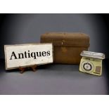 A LARGE ANTIQUE METAL TRUNK WITH A WOODEN ENAMEL ADVERTISING BOARD AND A VINTAGE SCALE.