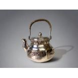 A JAPANESE MIXED METAL TEAPOT. SILVERED COPPER & BRASS, DECORATED WITH RELIEF FOLIATE SPRIGS. 17 X