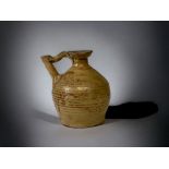 A CHINESE BUFF GLAZE POTTERY EWER. HAND THROWN WITH APPLIED NARROW SPOUT. SIGNED TO BASE. 12CM TAL