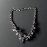 A LADIES STERLING SILVER NECKLACE. SET WITH PURPLE & CLEAR CRYSTAL DROPS. GROSS WEIGHT - 70.7G