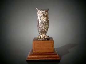 A Hallmarked sterling silver Owl figure, mounted on a wooden stepped plinth. Not filled. 137g silver