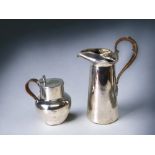 TWO 19TH CENTURY SILVER PLATE JUGS. INCLUDING A JAMES DEAKIN CLARET JUG. HEIGHT - 24CM