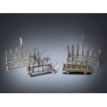 A COLLECTION OF FOUR SILVER PLATE TOAST RACKS.
