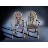 A PAIR OF ERCOL STYLE WHEEL BACK CARVER CHAIRS.