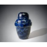 AN UNUSUAL THICK CASED GLASS LIDDED URN. MARBLE EFFECT DESIGN. HEIGHT - 17.5CM