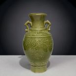 A Longquan style Celadon porcelain vase. 20th-century. Carved foliate design, with twin bamboo hand