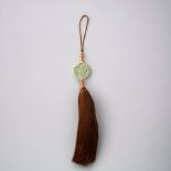 A CHINESE CARVED JADE & AGATE AMULET TASSEL. CARVED C DRAGON WITH A SMALLER DRAGON TO INTERIOR, HELD