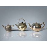 A COLLECTION OF THREE 19TH CENTURY SILVER PLATE TEAPOTS. INCLUDING A JAPANESE STYLE BATCHELORS TEAPO