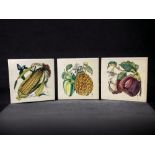 A SET OF THREE HANDPAINTED 'FRUIT' TILES. ARTIST MONOGRAM MARK TO LOWER RIGHT. 6" X 6"
