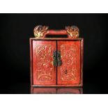 A Qing dynasty Chinese carved red lacquer Scholars cabinet. Carved and gilded Dragon handle and styl