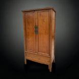 A TALL CHINESE ELM NOODLE CUPBOARD. TAPERED FORM, WITH FITTED INTERIOR. IN THE MING STYLE.