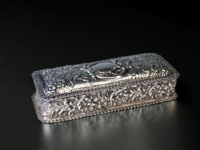 A Silver embossed oblong lidded trinket box. Synyer & Beddoes. Birmingham 1903 hallmarks.
