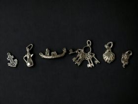 6 Vintage silver charms.
