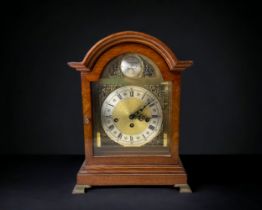 An Oak cased chiming mantel clock 'Tempus Fugit'. 38.5cms tall.