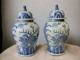 A LARGE PAIR OF CHINESE BLUE & WHITE TEMPLE JARS & COVERS. BALUSTER FORM, HAND PAINTED WITH GUARDIAN