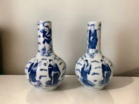 A PAIR OF CHINESE PORCELAIN BLUE & WHITE BOTTLE VASES. PAINTED WITH EIGHT IMMORTALS AMONGST THE