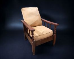 A CARVED OAK ADJUSTABLE PLANTATION CHAIR. EARLY 20TH-CENTURY. WITH CARVED BARLEY TWIST ARMS.