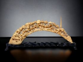 A CHINESE CARVED HIPPO TOOTH BRIDGE. INTRICATELY CARVED WITH NUMEROUS LANDSCAPE SCENES. ON CARVED