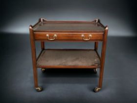 A VINTAGE MAHOGANY TEA TROLLEY. WITH CENTRAL DRAWER, ON FOUR CASTERS.
