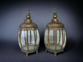 A PAIR OF METAL & GLASS PANELLED HANGING LANTERNS. HEIGHT - 48CM