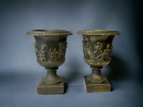 A PAIR OF LARGE RESIN ROMAN STYLE URNS. HEIGHT - 37CM