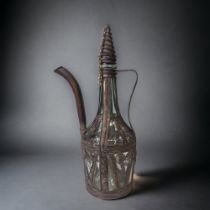 A GREEK METAL FILIGREE ON GLASS EWER. HEIGHT - 29CM