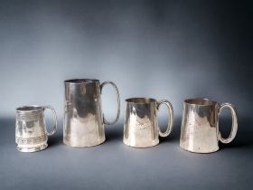 FOUR SILVER PLATE TANKARDS.
