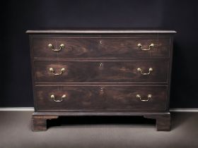 A VICTORIAN MAHOGANY THREE DRAWER CHEST OF DRAWERS.