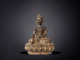 A 19TH CENTURY TIBETAN GILT BRONZE SHAKYAMUNI BUDDHA. ROBES ADORNED WITH SCROLLING DRAGONS. HEIGHT -