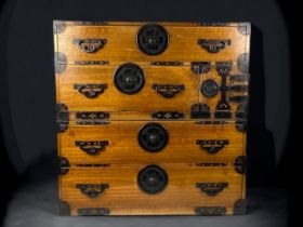 A 19TH CENTURY JAPANESE ISHO-DANSU KIMONO CHEST. MEIJI PERIOD. KIRI (PAULOWNIA) WOOD, ADORNED WITH