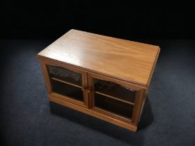 A VINTAGE GLASS FRONTED OAK CABINET.