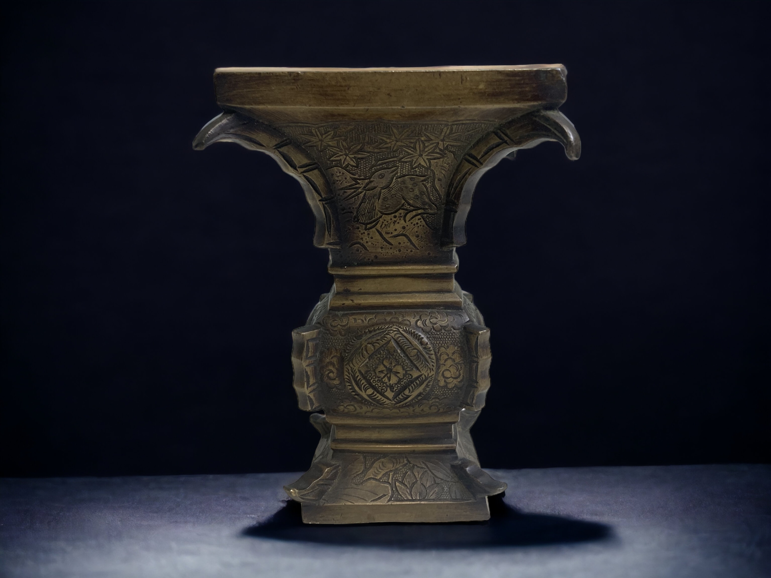 A CHINESE BRONZE CENSER. QING DYNASTY. ARCHAISTIC FORM, ENGRAVED WITH DEET, BIRDS & FLOWERS.