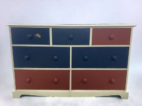 A LARGE PAINTED PINE CHEST OF DRAWERS.